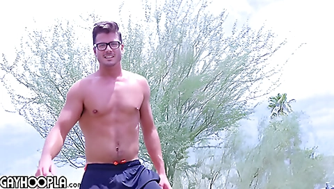 Brunette and muscular teen plays football outdoors